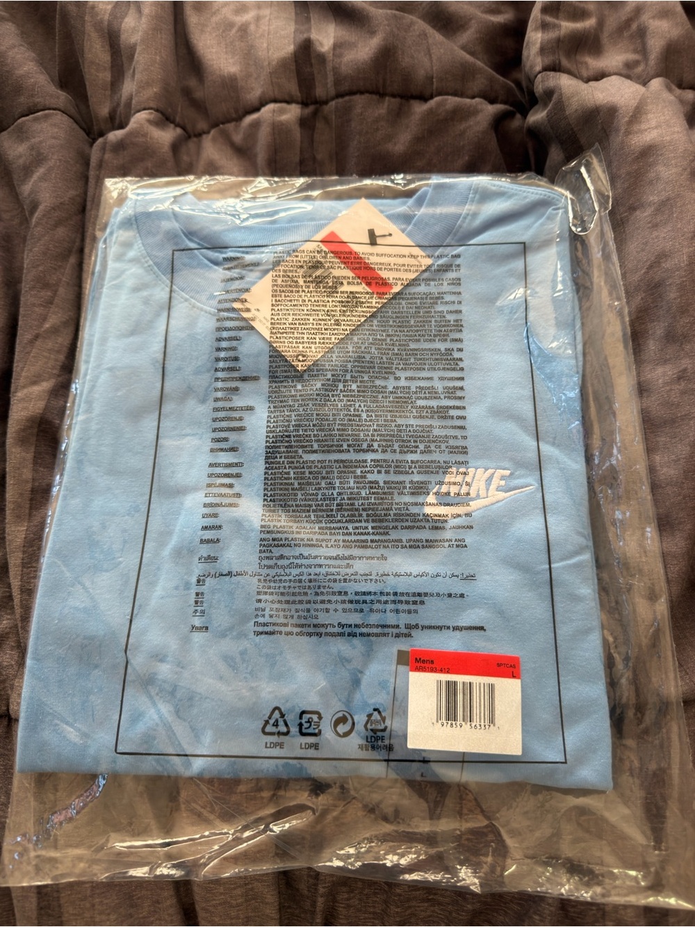 Nike Light Blue T-Shirt with White Swoosh Logo